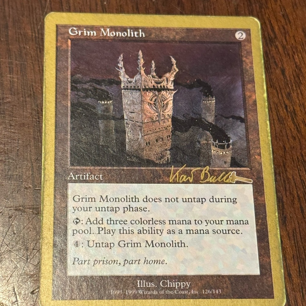 Gold boarder Grim Monolith Artifact Card